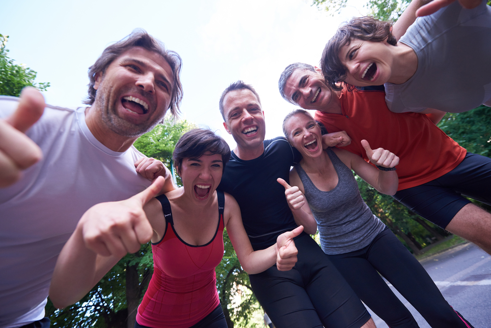 jogging people group, friends have fun,  hug and stack hands together after training